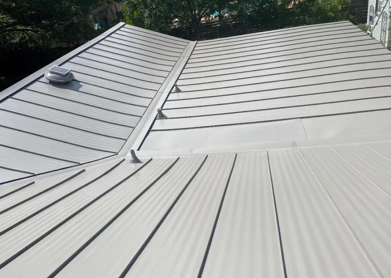 Solar attic fan installed on a metal roof for Roof Ventilation in Oelwein